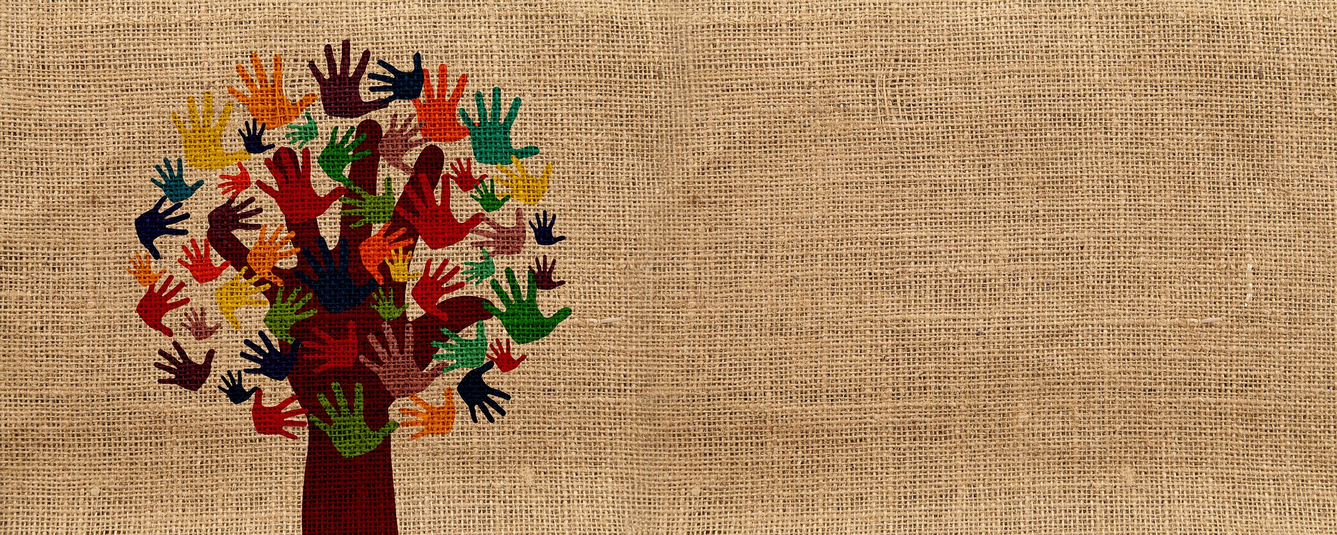 Tree graphic with leaves that look like hands, painted on burlap