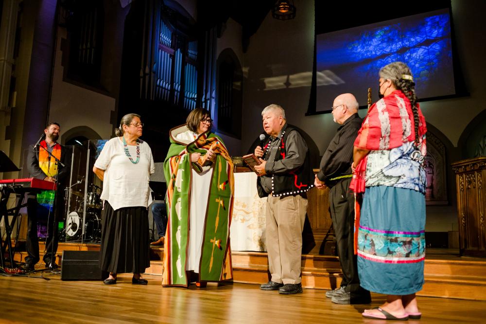 Moderator Carmen Lansdowne receives gifts from the Indigenous church