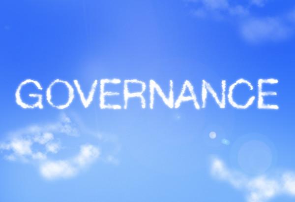 The word "governance" written in clouds against a blue sky